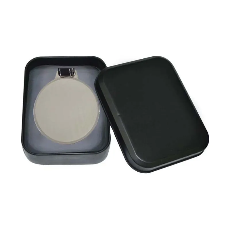 Metal luggage tag on a leather strap in a tin box